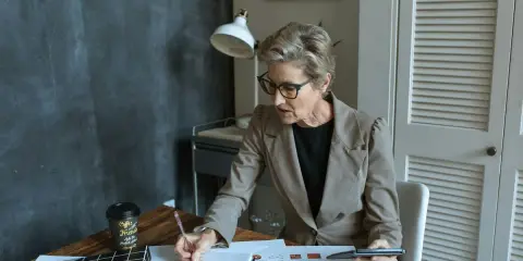 Mujer concentrada revisando documentos, quizás analizando el articulo 1566 del código civil.