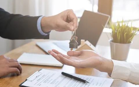 Entrega de llaves de un piso de alquiler. El agente inmobiliario da las llaves a un cliente. Ahora puedo echar a mi pareja del piso de alquiler.