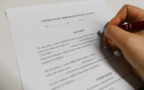 Firma de un contrato de arrendamiento de vivienda, un documento legal clave.